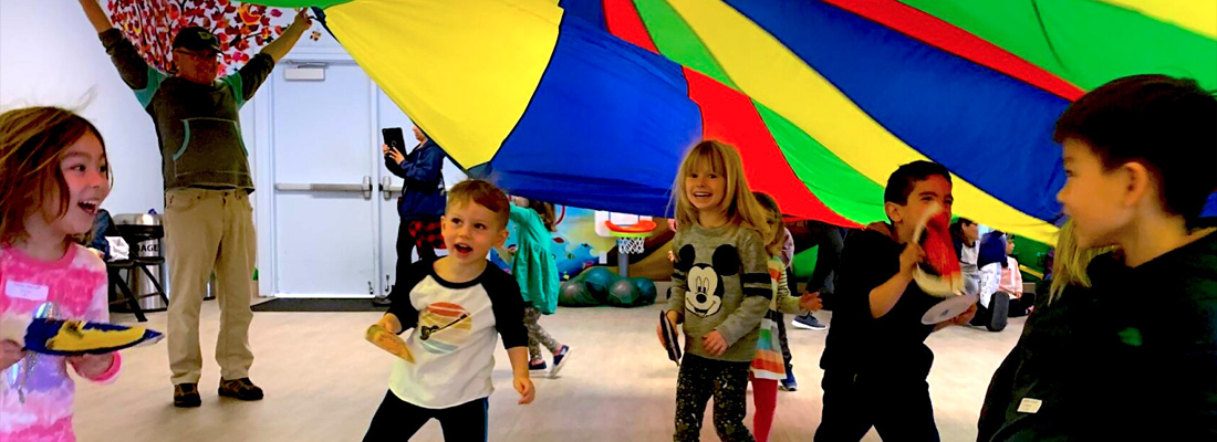 kids playing with a parachute